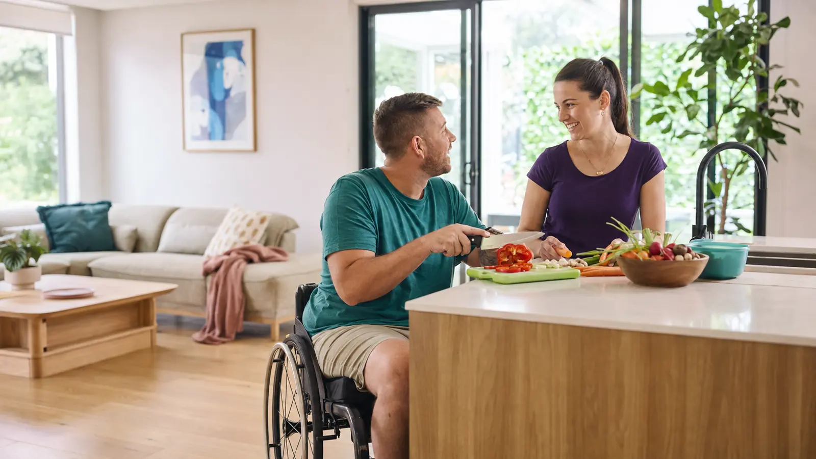 NDIS participant and support worker preparing a meal in accessible respite accommodation